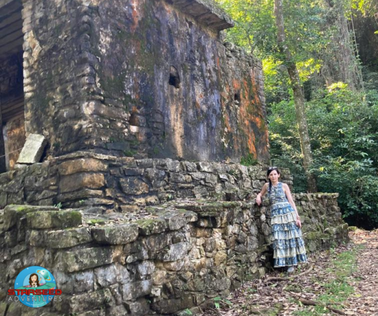 Althea Provost standing beside the Forgotten Temple at Palenque, Mexico — an ancient moss-covered ruin in the jungle, part of her Starseed Mexico Adventure.