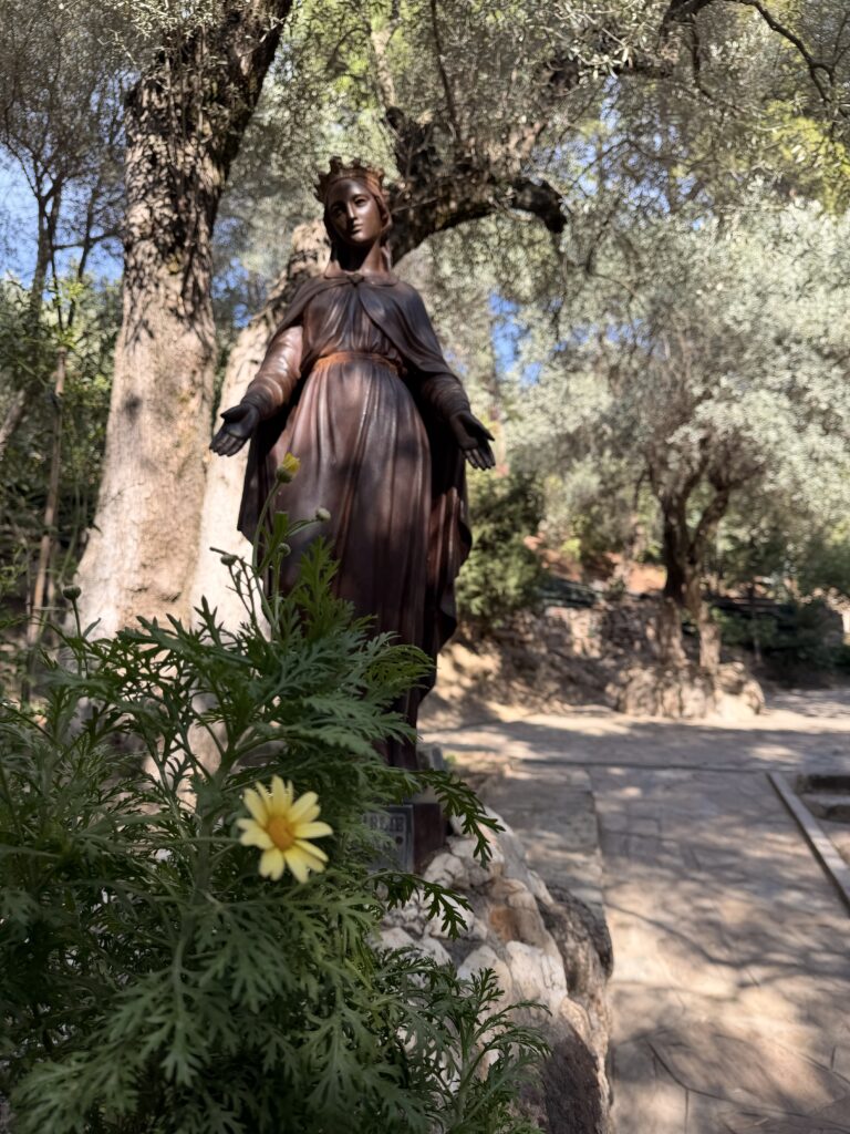 Starseed Türkiye Adventure 2026, statue of Mother Mary standing among olive trees near Mary's House above Ephesus, Türkiye.