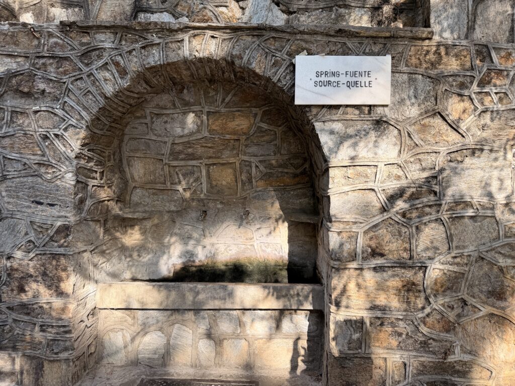 Starseed Türkiye Adventure 2026, historic stone spring and fountain near Mary's House featuring textured masonry and a natural water source.